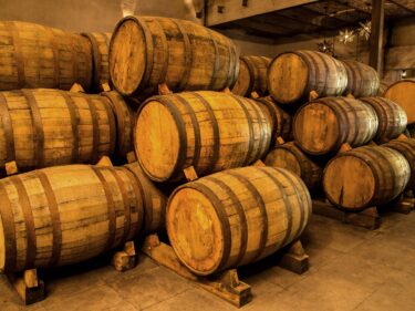 wooden barrels stacked in storage cellar