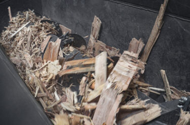 Shredded Euro pallets in the hopper of a shredder