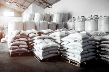 warehouse with filled woven big bags and jumbo bags